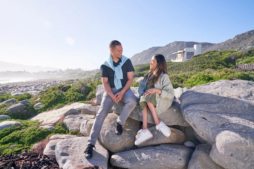 disabled woman chatting with a friend on rocks on a sunny day