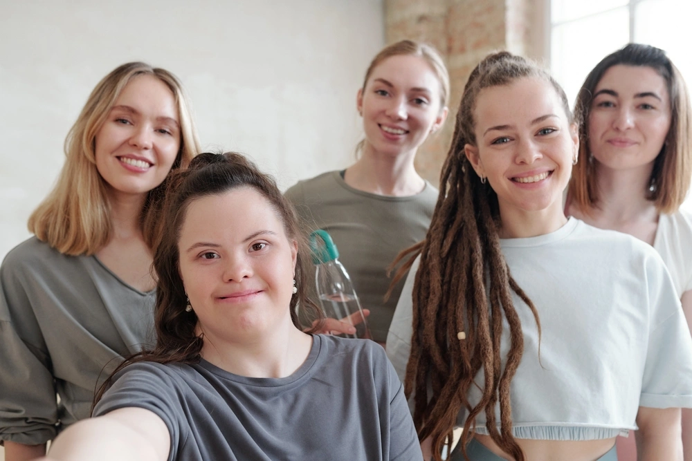 woman with down syndrome disability clicking selfie with her friends